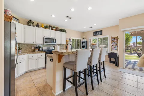 a view of a dining room with furniture large windows and wooden floor