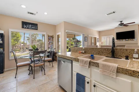 a dining room with furniture and a floor to ceiling window