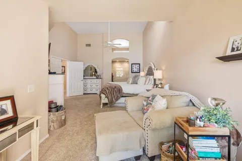 a bedroom with a bed a flat screen tv and dresser