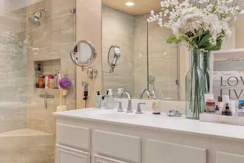 a bedroom with a bed tv and a window