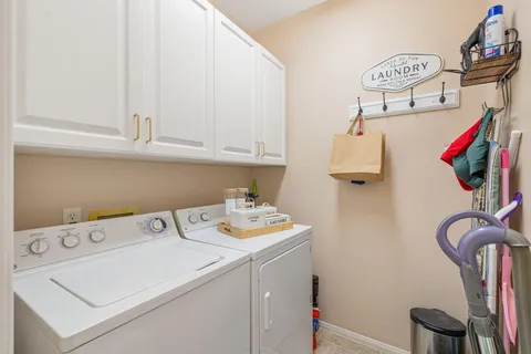 a view of a workspace with furniture and a flat screen tv