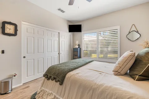 a view of a patio with couches plants and a big yard