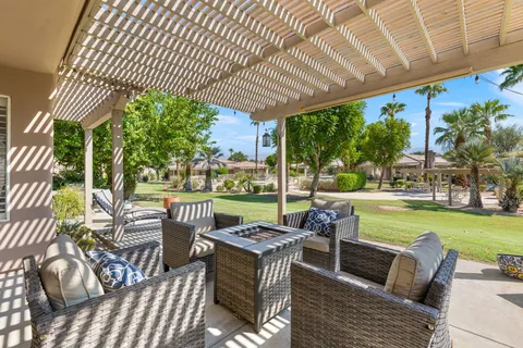 a view of a house with backyard porch and sitting area