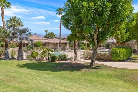 a front view of a house with a yard and trees