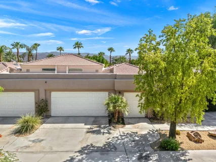 a view of a patio with table and chairs under an umbrella
