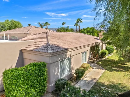 an aerial view of residential building with outdoor space and trees