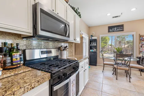 a stove top oven sitting inside of a kitchen