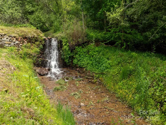 an aerial view of a house with pool table and chairs