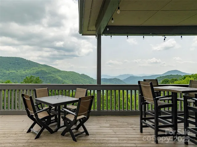 a view of a mountain range with lush green forest
