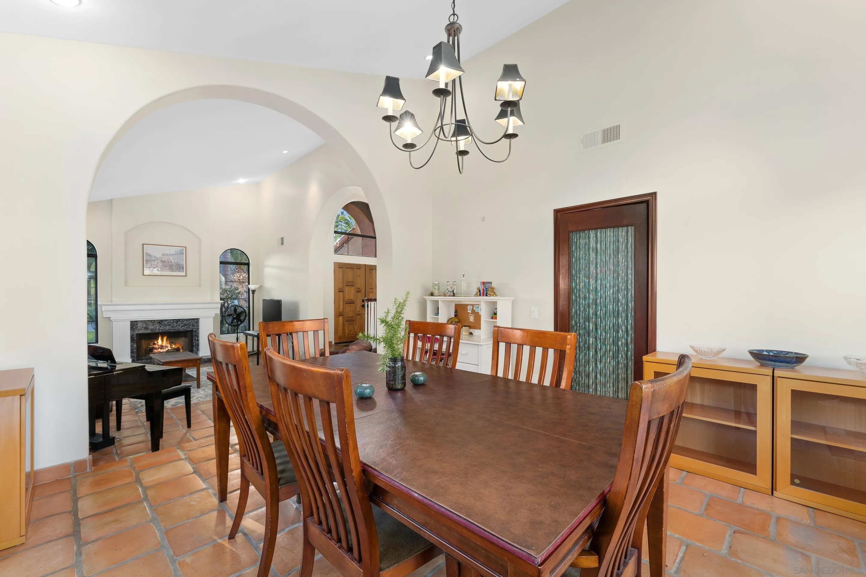 1027 Summer Holly Lane Encinitas, CA 92024 - Photo 11 of 29 a view of a dining room with furniture a chandelier and wooden floor