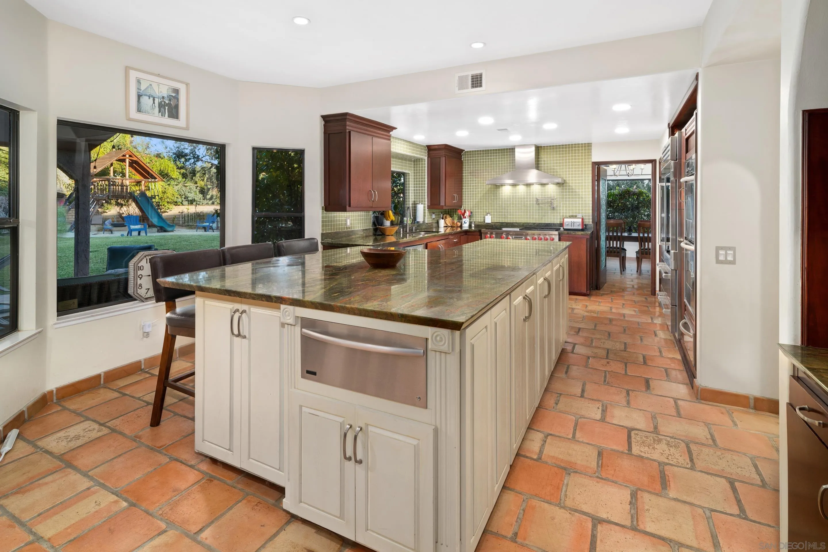 1027 Summer Holly Lane Encinitas, CA 92024 - Photo 13 of 29 a kitchen with kitchen island granite countertop lots of counter top space
