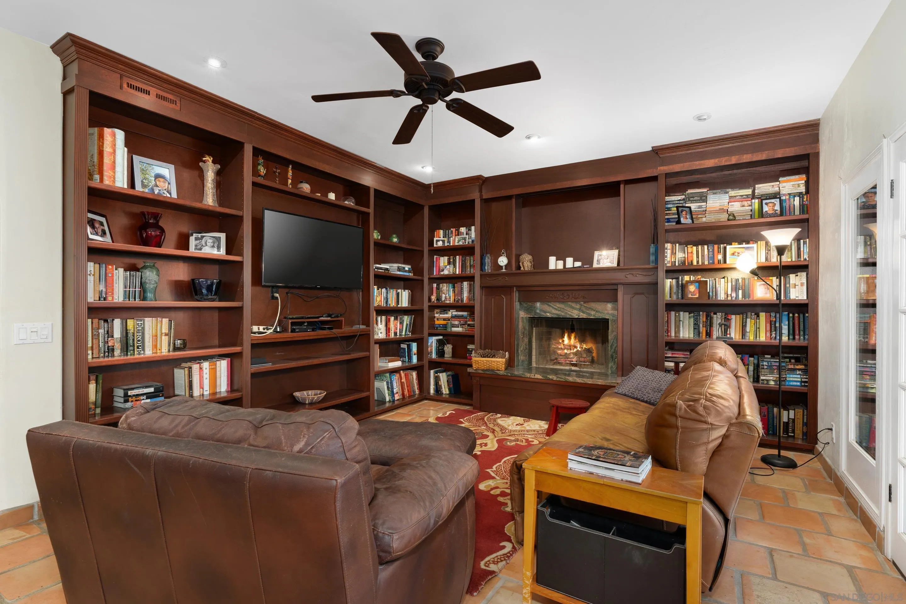 1027 Summer Holly Lane Encinitas, CA 92024 - Photo 14 of 29 a living room with furniture a flat screen tv and a fireplace