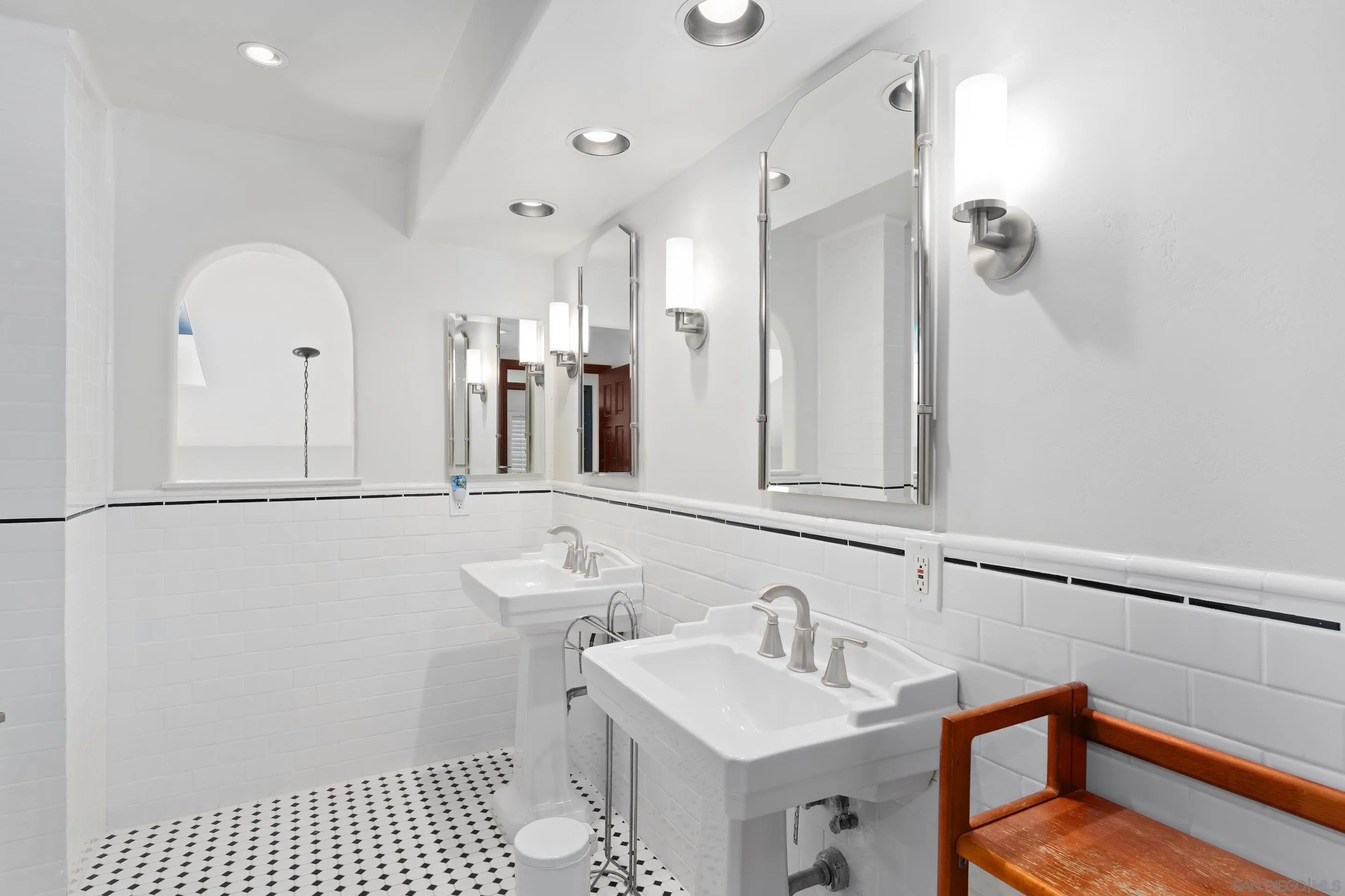 1027 Summer Holly Lane Encinitas, CA 92024 - Photo 22 of 29 a bathroom with a sink a toilet and a mirror