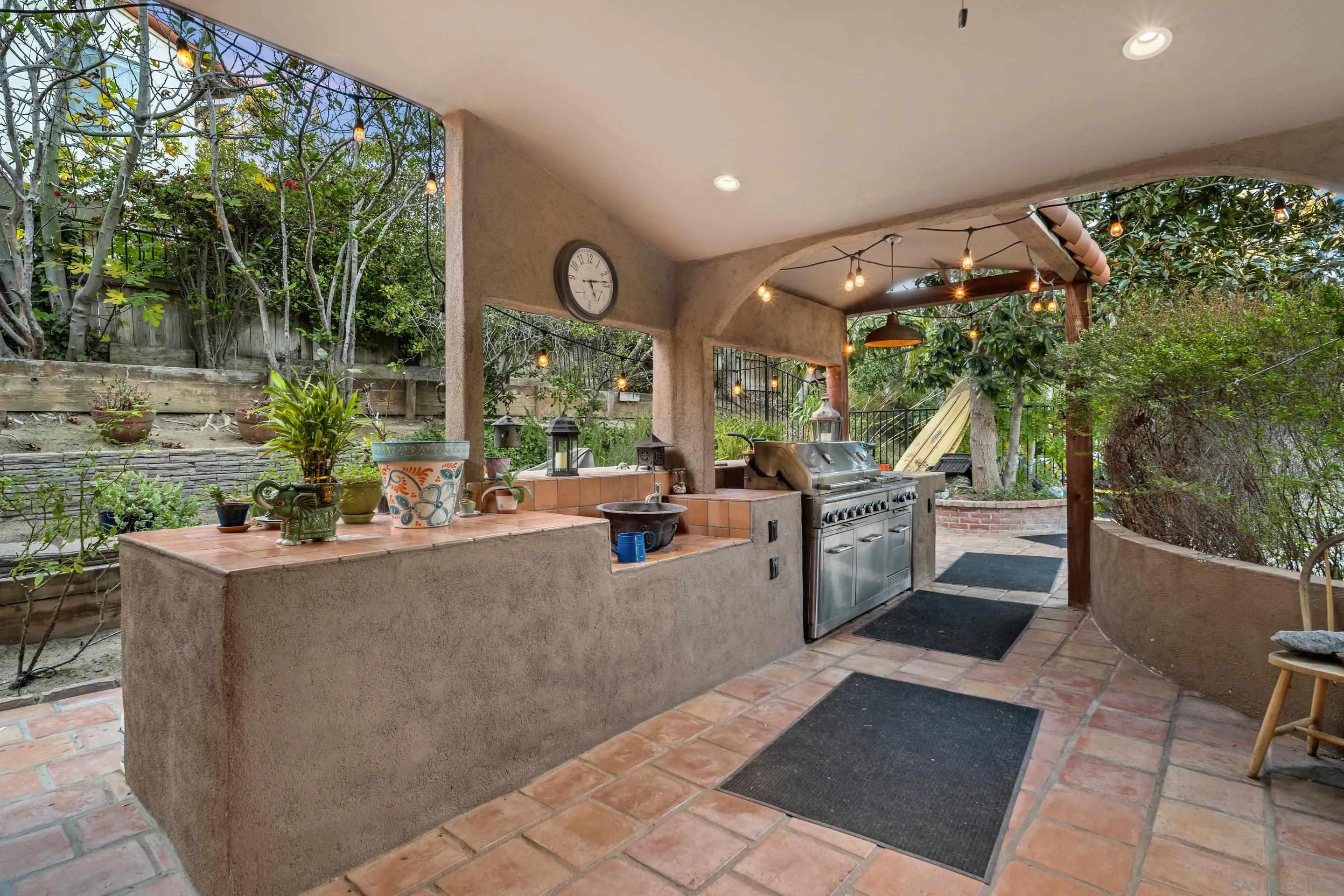 1027 Summer Holly Lane Encinitas, CA 92024 - Photo 25 of 29 a living room with patio furniture and a garden