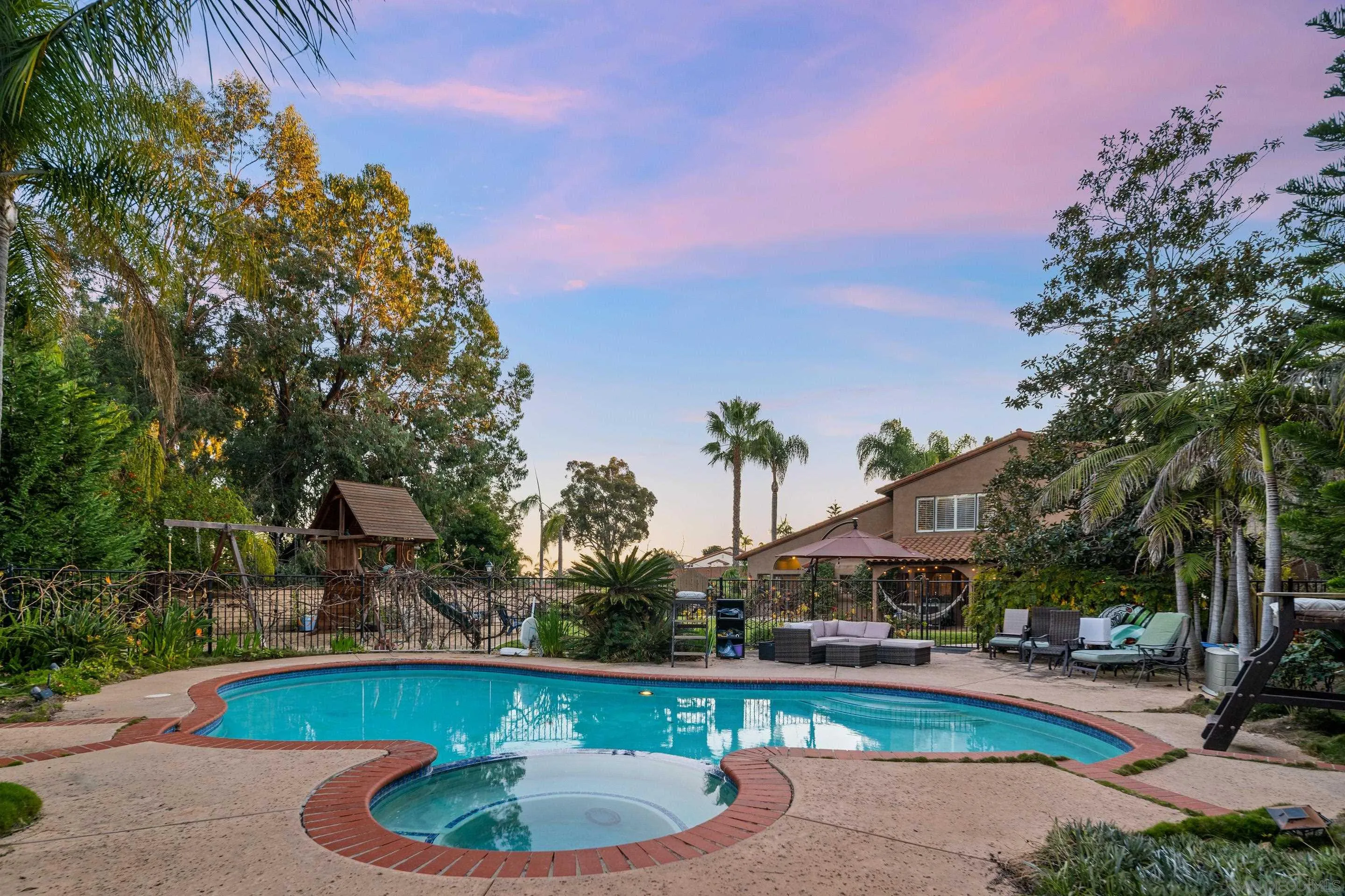 1027 Summer Holly Lane Encinitas, CA 92024 - Photo 27 of 29 a swimming pool with outdoor seating and yard