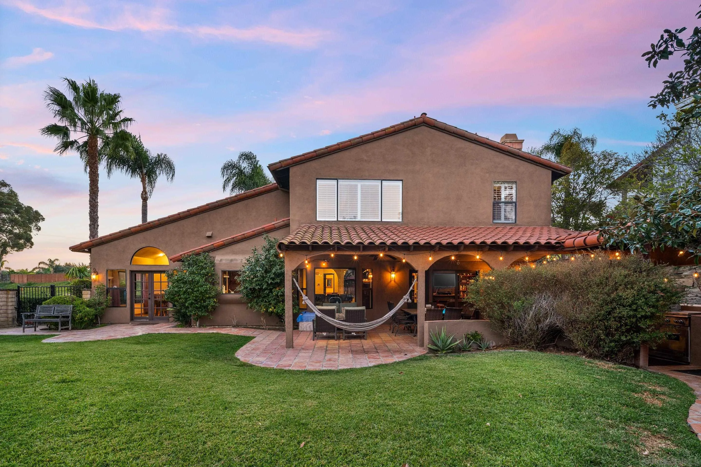 1027 Summer Holly Lane Encinitas, CA 92024 - Photo 3 of 29 a backyard of a house with table and chairs