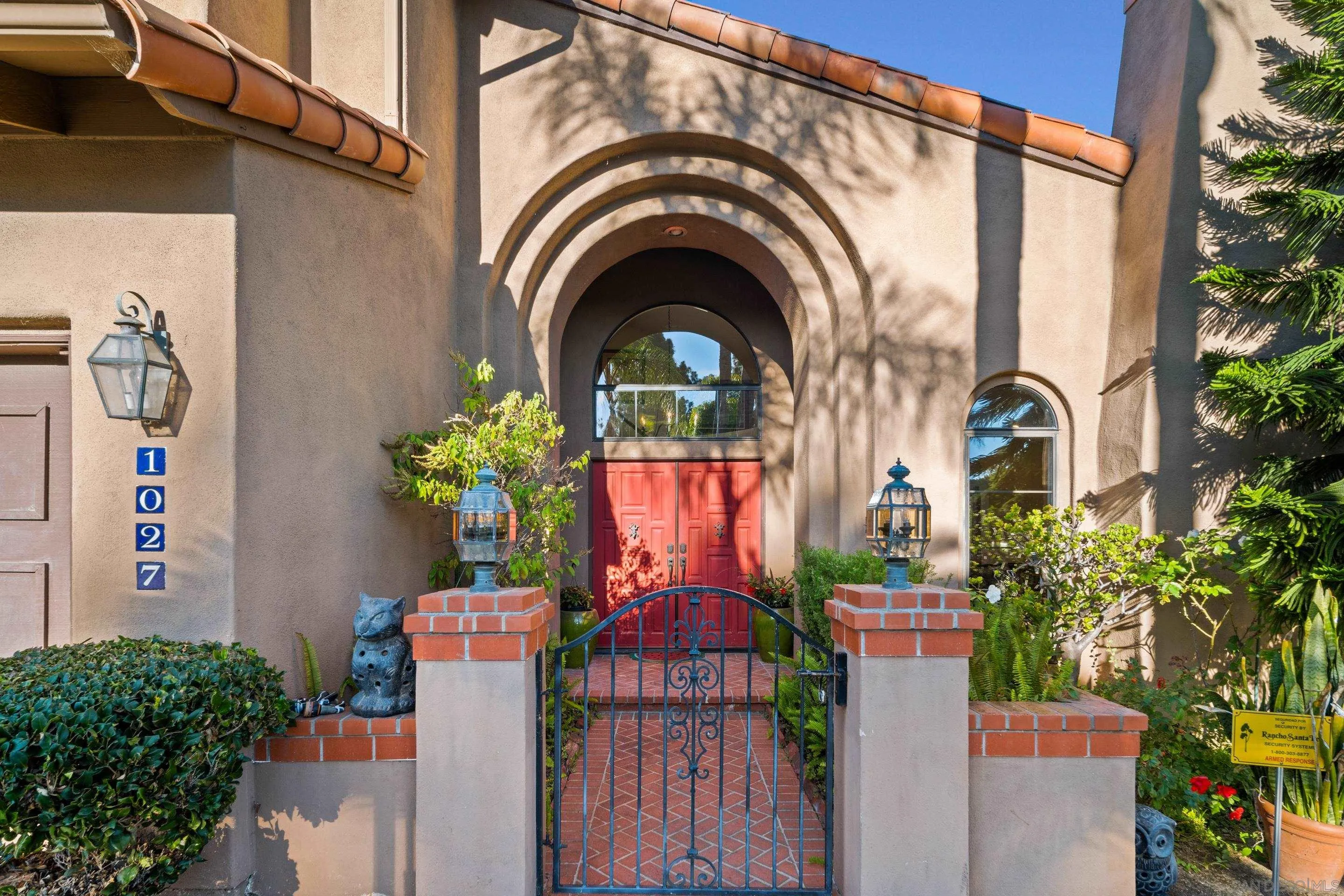 1027 Summer Holly Lane Encinitas, CA 92024 - Photo 6 of 29 a view of a house with large windows and a flower plants