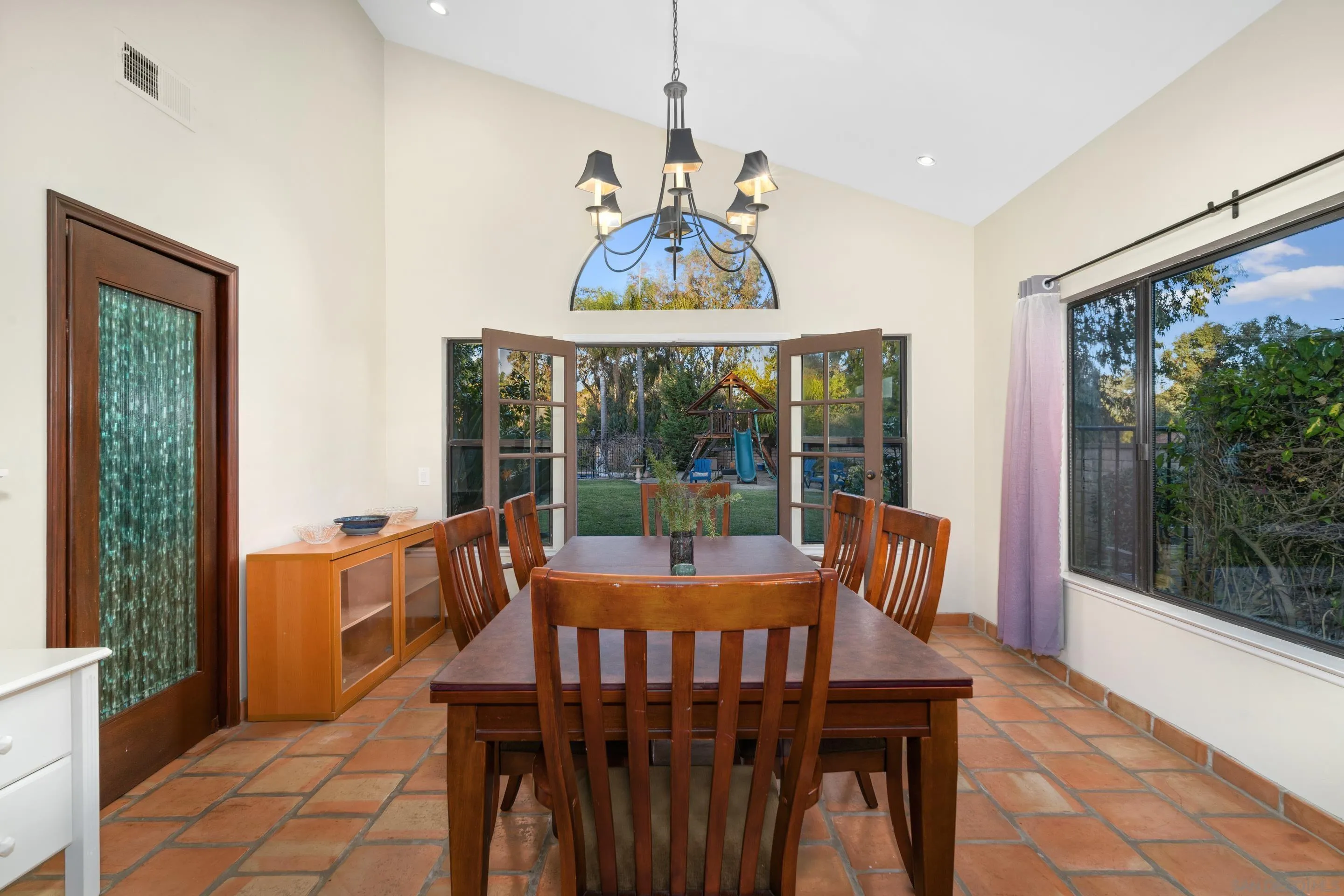 1027 Summer Holly Lane Encinitas, CA 92024 - Photo 10 of 29 a view of a dining room with furniture large windows and wooden floor