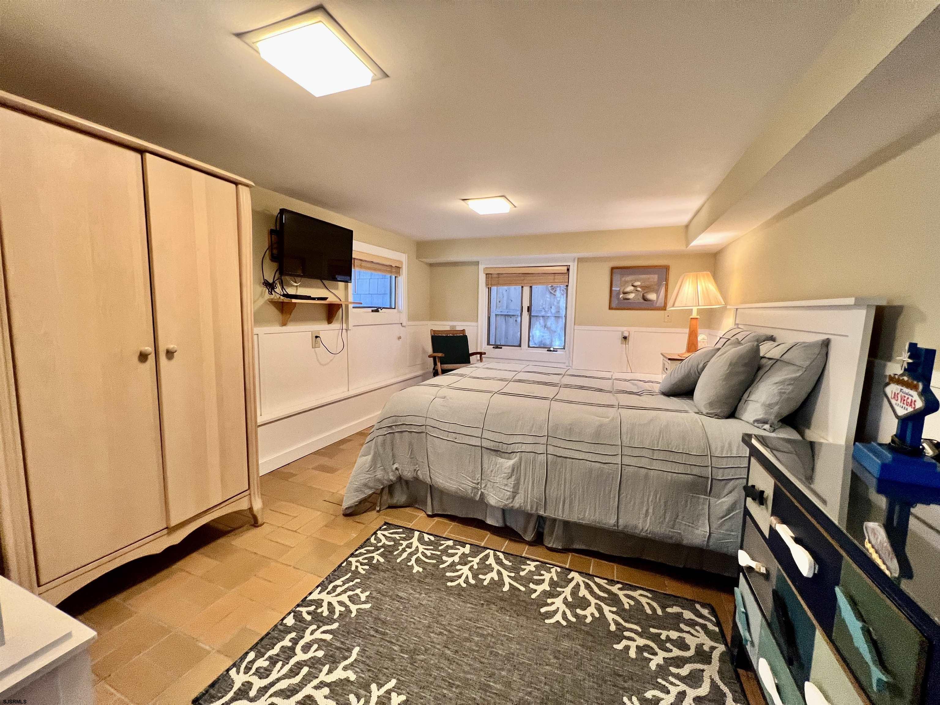 7 North Delavan Avenue, Unit MEMORIAL DAY LABOR DAY Margate City, NJ 08402 - Photo 15 of 60 a bed room with a bed and a television