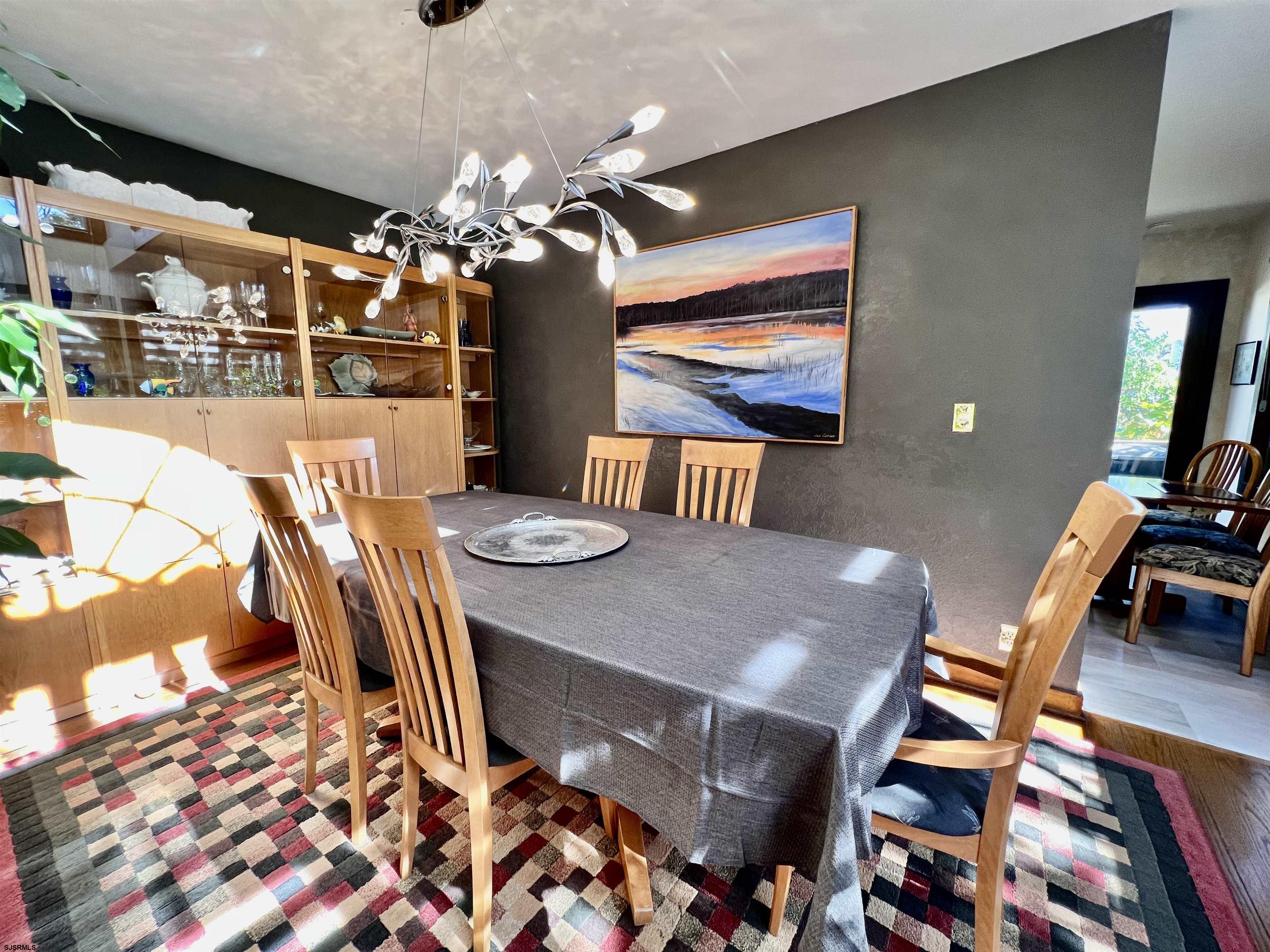 7 North Delavan Avenue, Unit MEMORIAL DAY LABOR DAY Margate City, NJ 08402 - Photo 23 of 60 a view of a dining room with furniture and chandelier