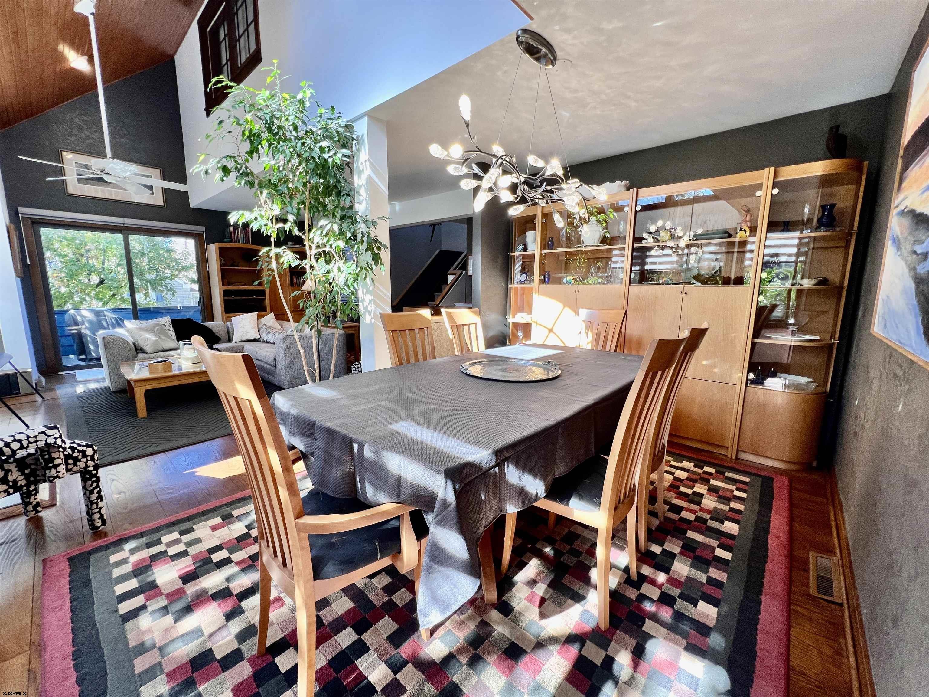 7 North Delavan Avenue, Unit MEMORIAL DAY LABOR DAY Margate City, NJ 08402 - Photo 24 of 60 a view of a dining room with furniture window and wooden floor