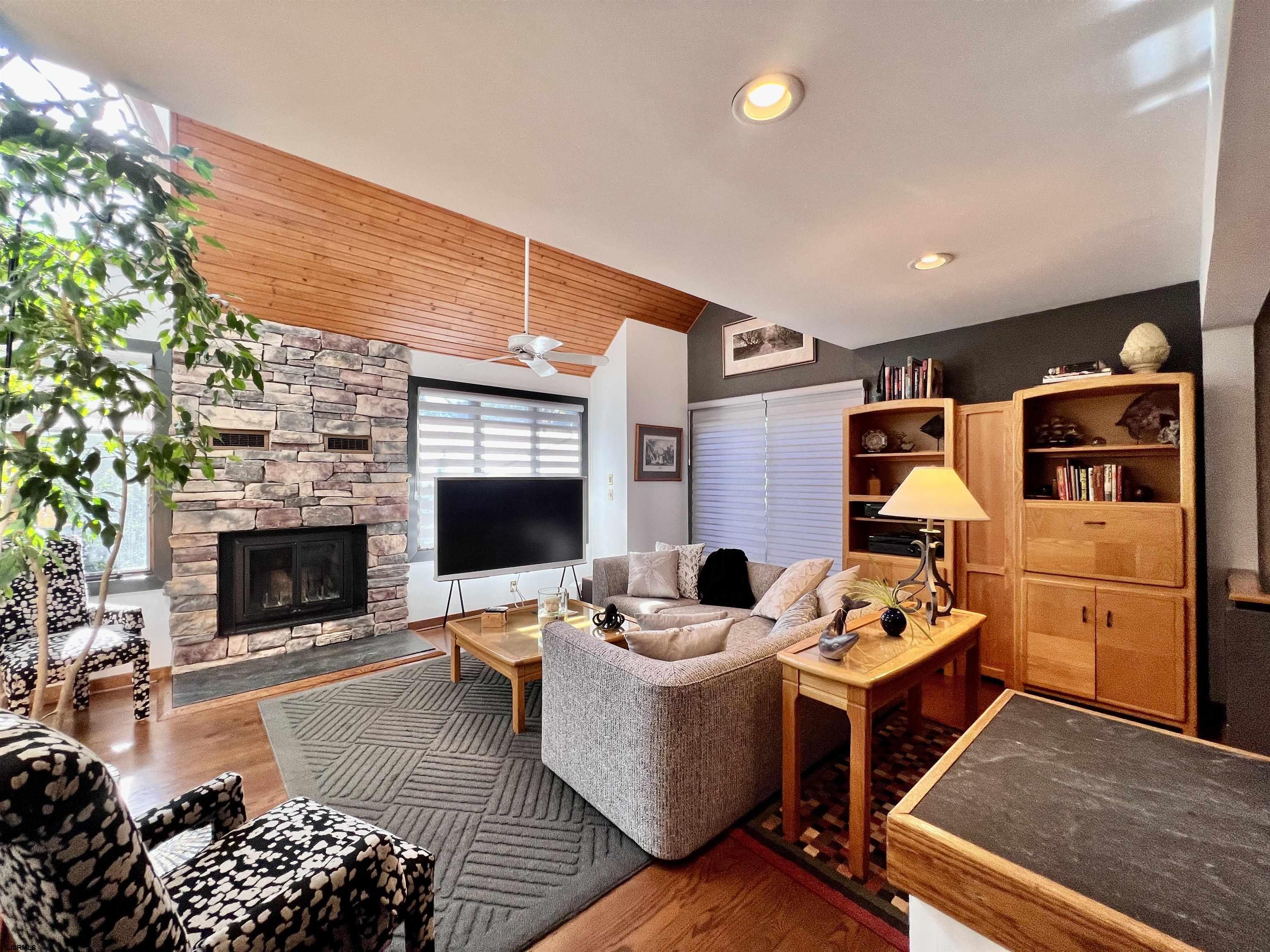 7 North Delavan Avenue, Unit MEMORIAL DAY LABOR DAY Margate City, NJ 08402 - Photo 37 of 60 a living room with fireplace furniture and a fireplace