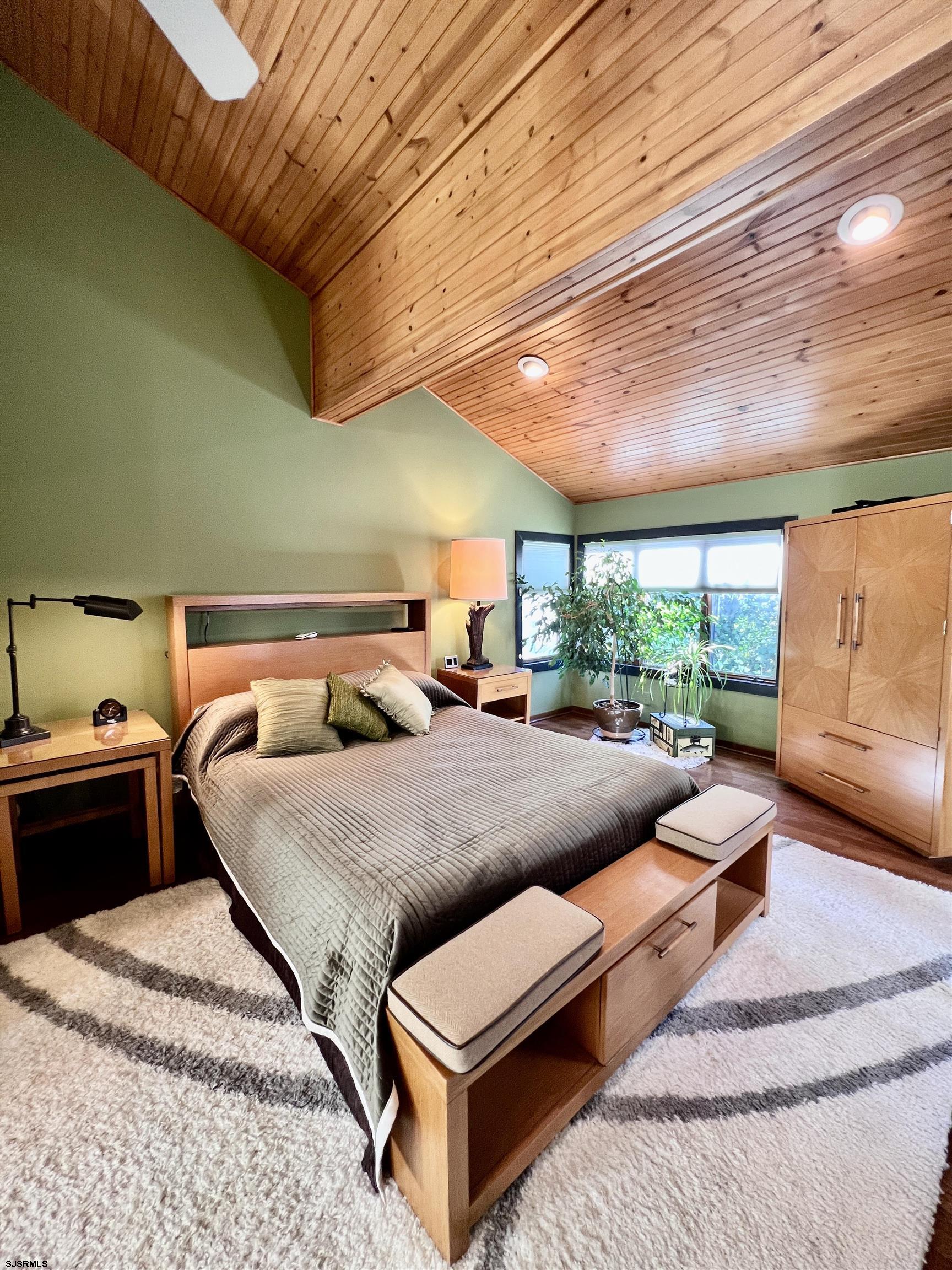 7 North Delavan Avenue, Unit MEMORIAL DAY LABOR DAY Margate City, NJ 08402 - Photo 44 of 60 a bedroom with furniture and a large window