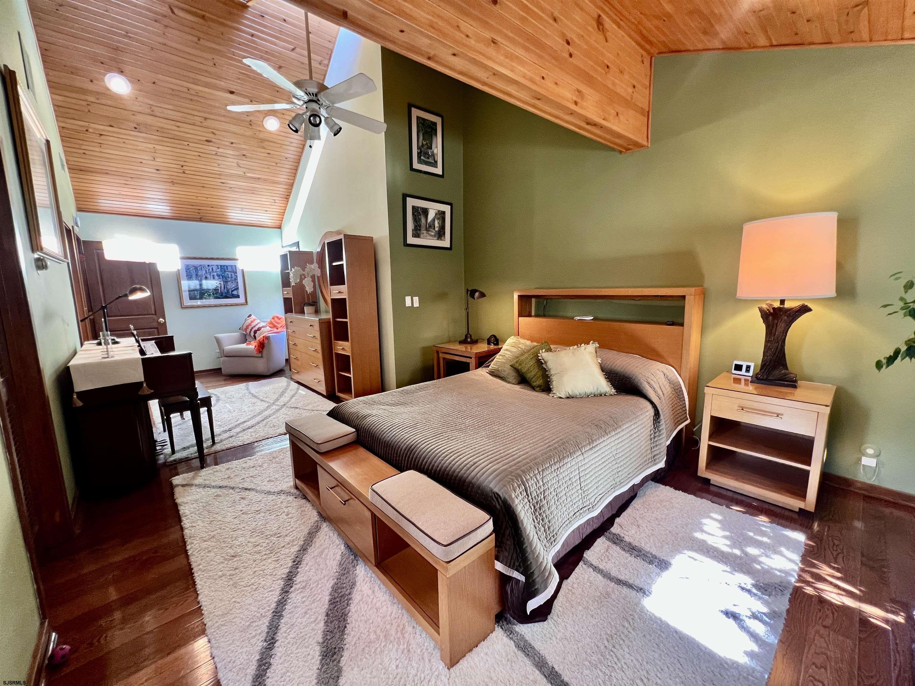 7 North Delavan Avenue, Unit MEMORIAL DAY LABOR DAY Margate City, NJ 08402 - Photo 46 of 60 a bedroom with a bed and wooden floor