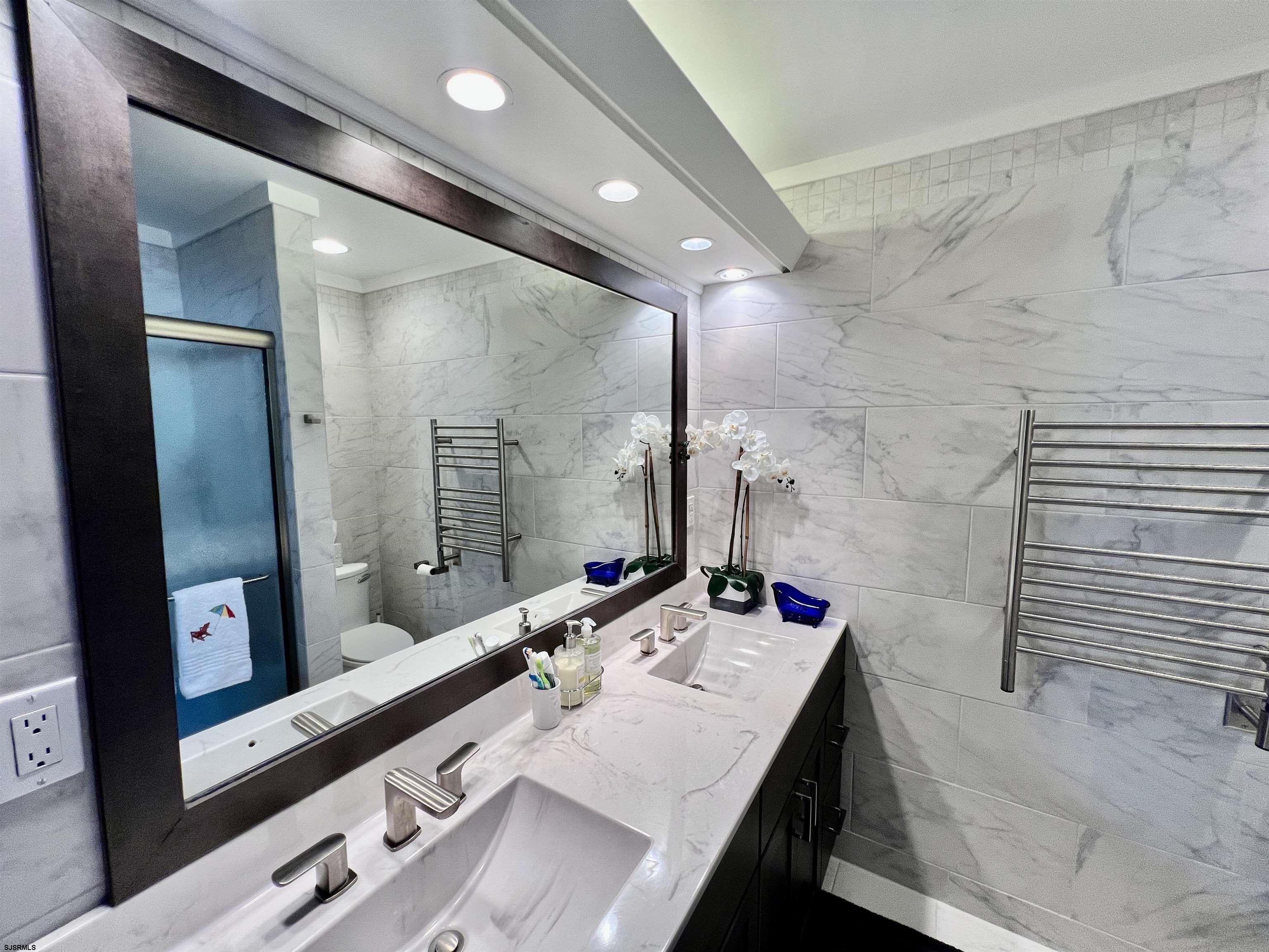 7 North Delavan Avenue, Unit MEMORIAL DAY LABOR DAY Margate City, NJ 08402 - Photo 48 of 60 a bathroom with a granite countertop sink a mirror and a shower