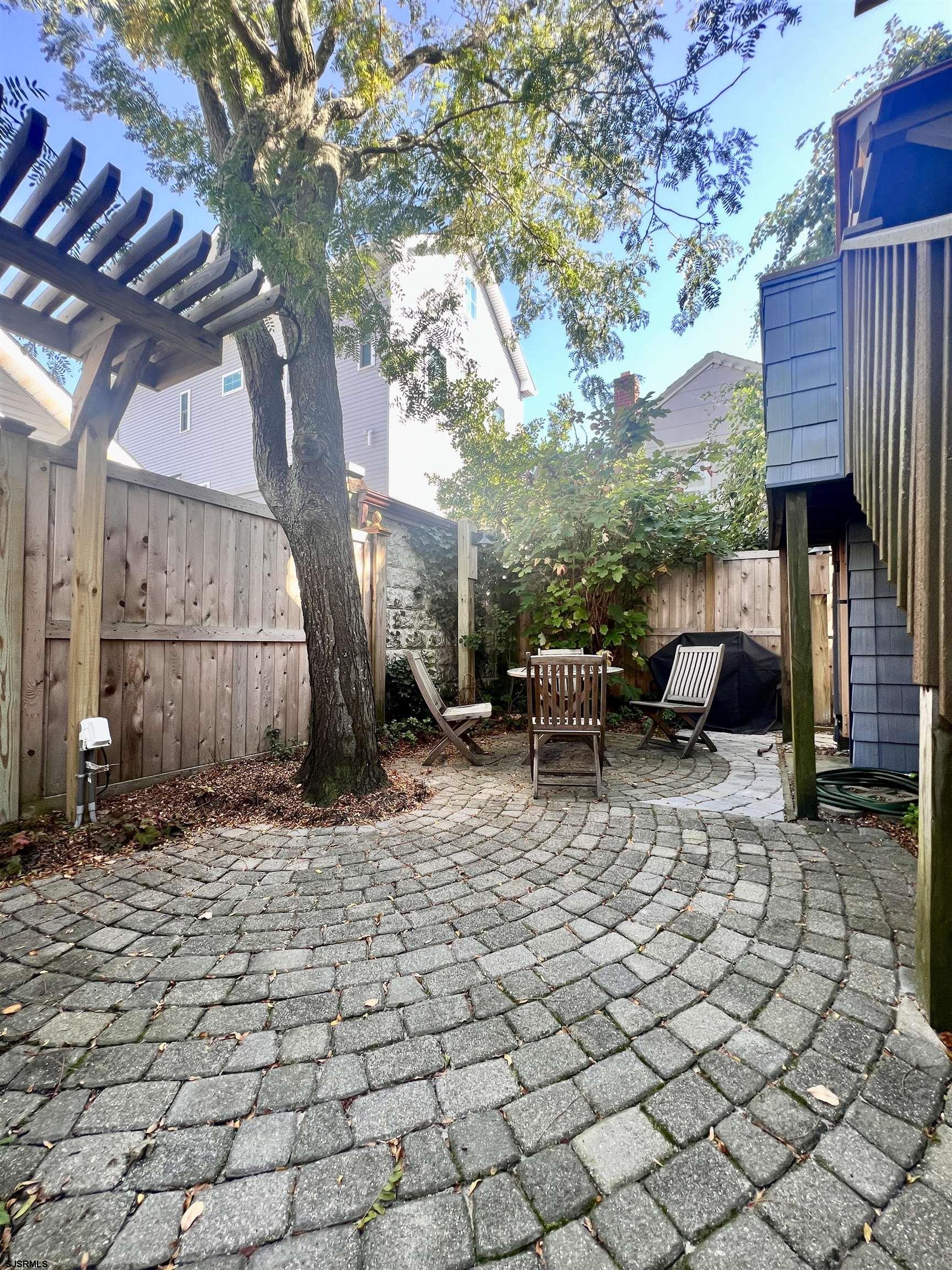 7 North Delavan Avenue, Unit MEMORIAL DAY LABOR DAY Margate City, NJ 08402 - Photo 51 of 60 a view of backyard with barbeque grill and outdoor seating