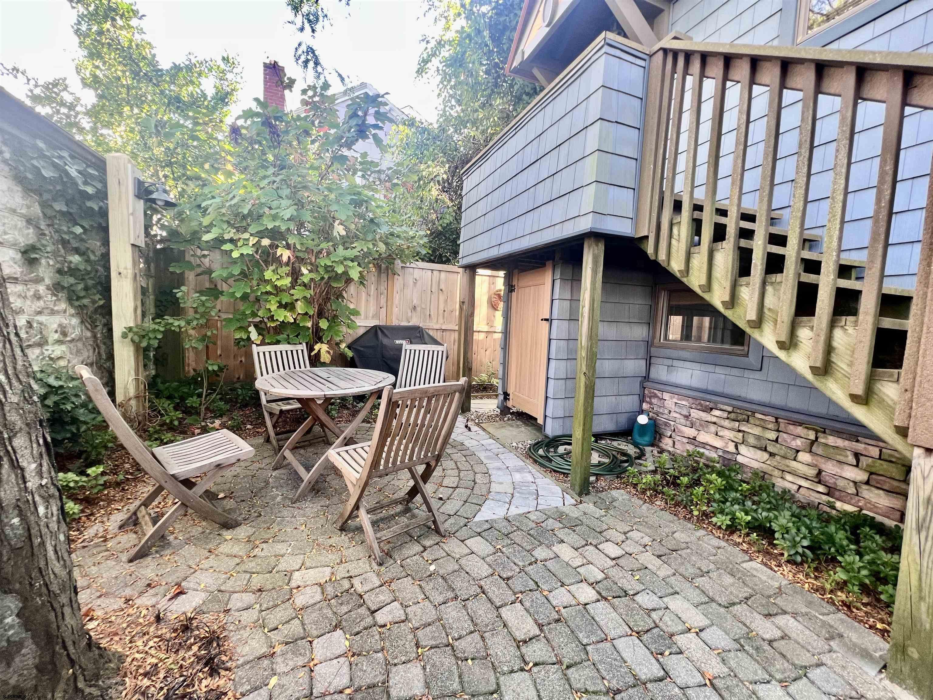 7 North Delavan Avenue, Unit MEMORIAL DAY LABOR DAY Margate City, NJ 08402 - Photo 57 of 60 a view of a chair and table in backyard
