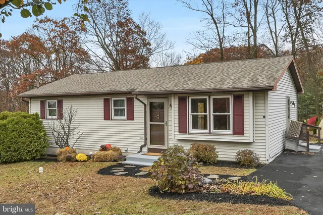 a front view of a house with sitting area
