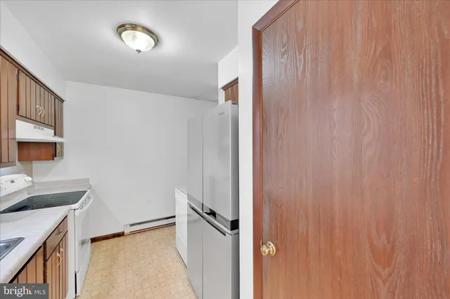 a kitchen with a sink cabinets and window