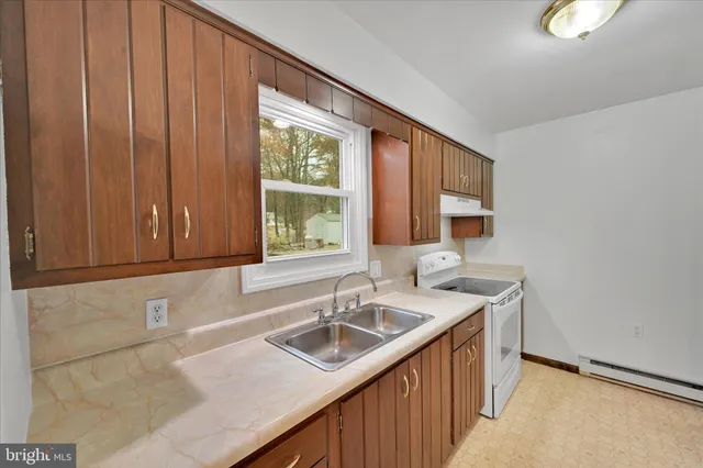 a view of a livingroom with a chandelier fireplace and windows