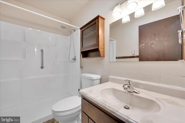 an empty room with a ceiling fan and window