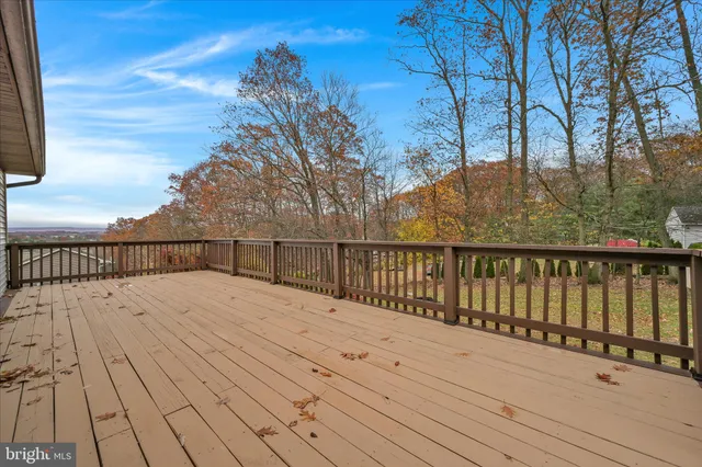 a view of a house with a wooden deck
