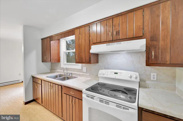 a kitchen with a stove and a sink