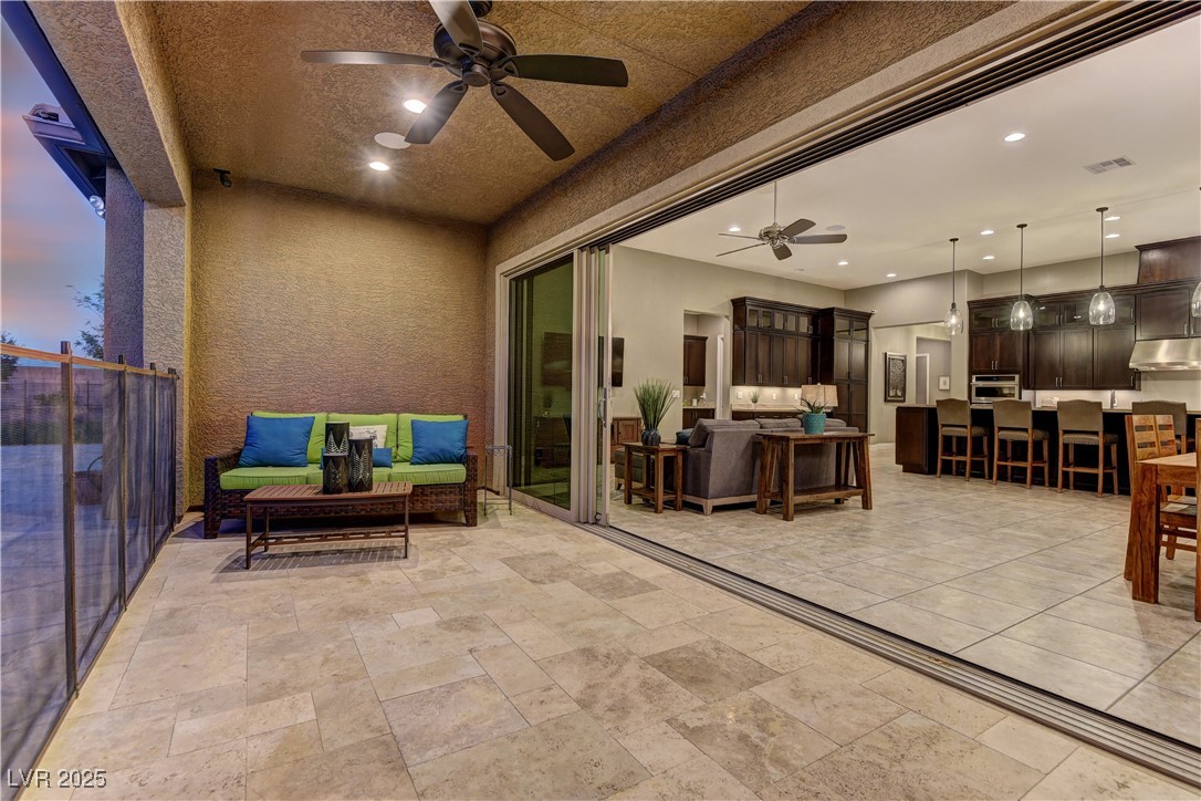 8411 South Cimarron Road Las Vegas, NV 89113 - Photo 30 of 46 Stacked slider doors and covered patio, removable security fence