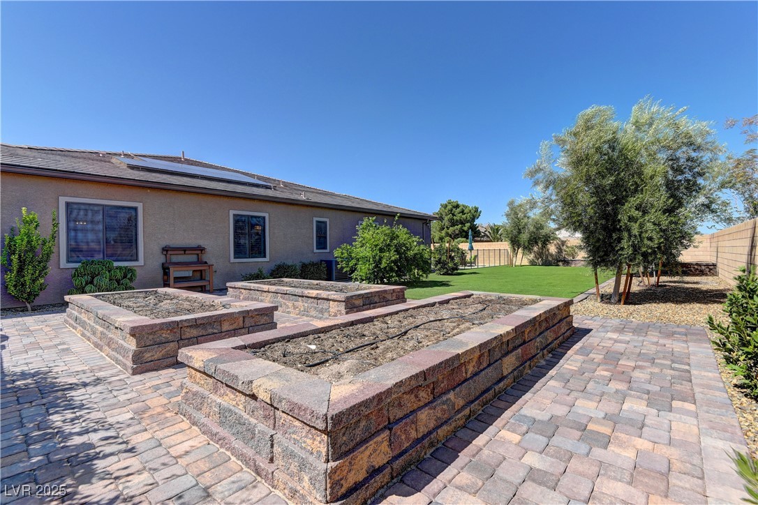 8411 South Cimarron Road Las Vegas, NV 89113 - Photo 41 of 46 Raised garden beds and Meyer lemon, key lime, peach, tangerine, and pomegranate trees