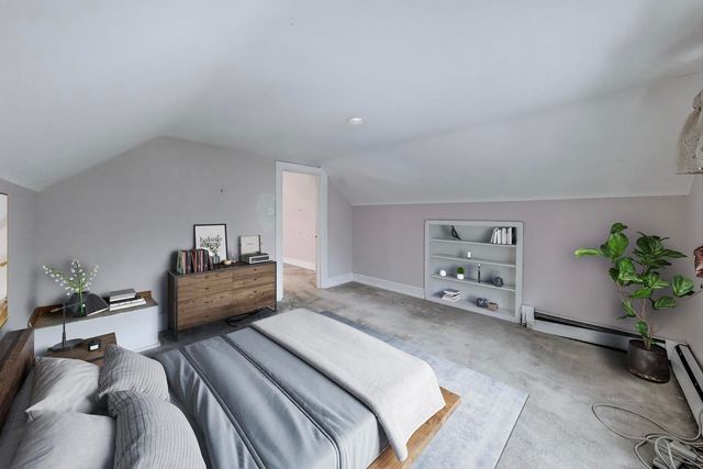 a bedroom with a bed and a potted plant