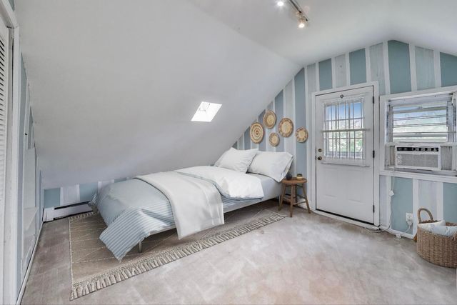 a bedroom with a bed and cabinets