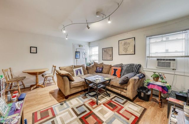 a kitchen with stainless steel appliances a refrigerator a stove a sink dishwasher and a refrigerator with wooden floor