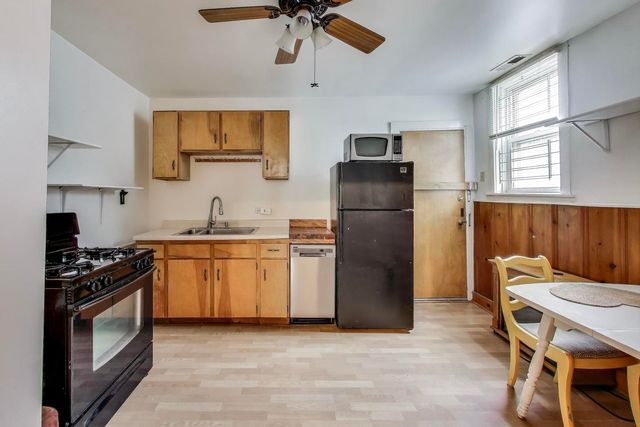a kitchen with stainless steel appliances a refrigerator and a stove top oven