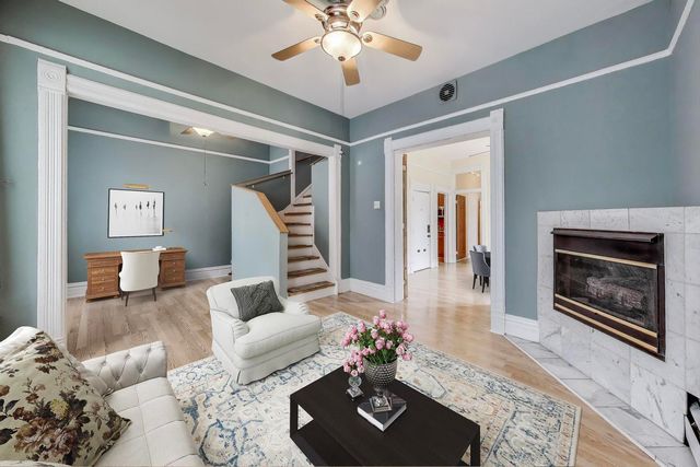 a living room with furniture a fireplace and a chandelier