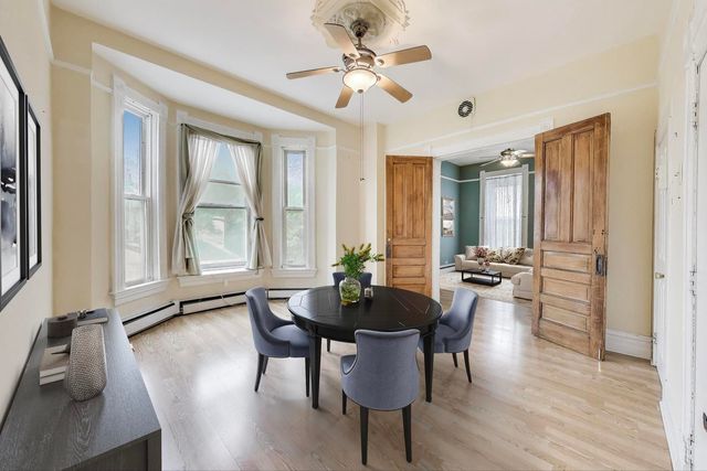 a view of a dining room with furniture and window