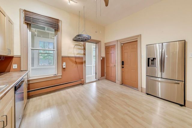 a kitchen with stainless steel appliances a refrigerator and a stove top oven