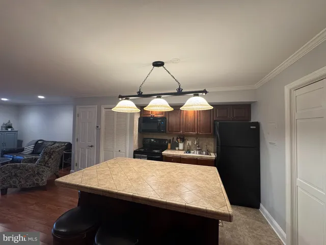 a bathroom with a sink shower and a mirror