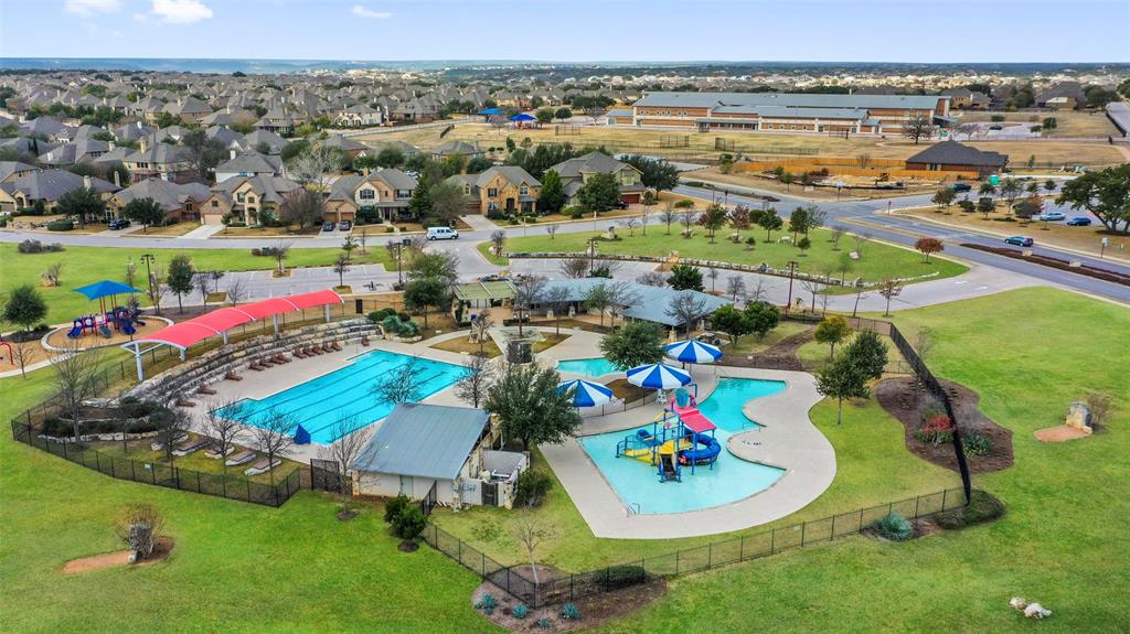 1765 Rowdy Loop, Unit 47 Leander, TX 78641 - Photo 35 of 39 A spacious community recreation center presents expansive swimming pools and active outdoor play areas.