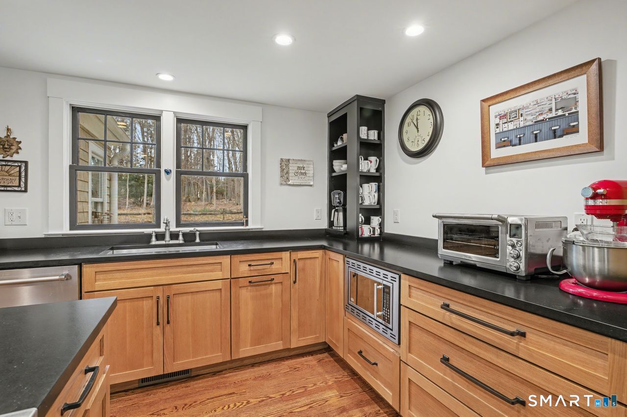 61 Bishop Lane Madison, CT 06443 - Photo 13 of 41 a kitchen with stainless steel appliances granite countertop a sink and a microwave