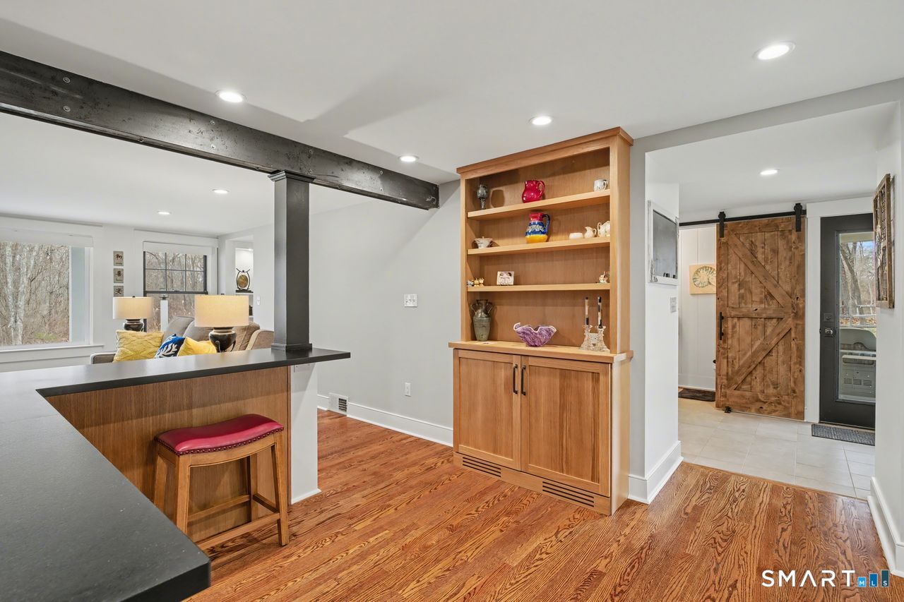 61 Bishop Lane Madison, CT 06443 - Photo 15 of 41 a room with stainless steel appliances wooden floor and large windows
